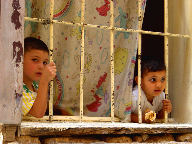 Boys Looking Through Bars In Saida